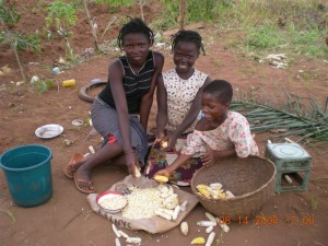 Frere Geoffry\'s sisters and a friend shelling corn