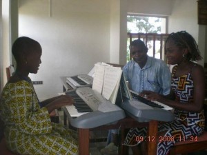 Lillain and Scholastic taking Piano lessons