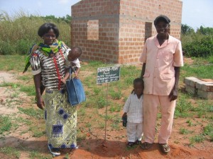 Paul and Honorine Dansou family in front of House