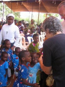 Sister Findlay showing pictures to children